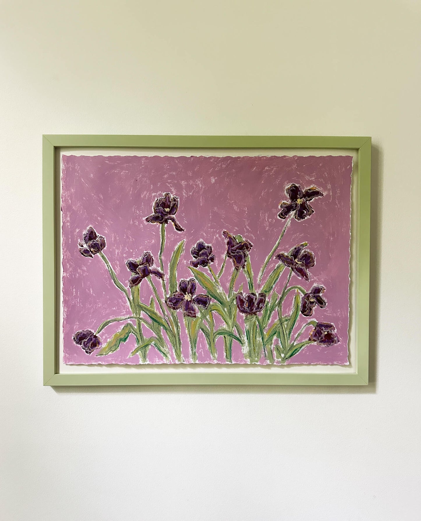 Framed artwork of purple flowers on a pink background