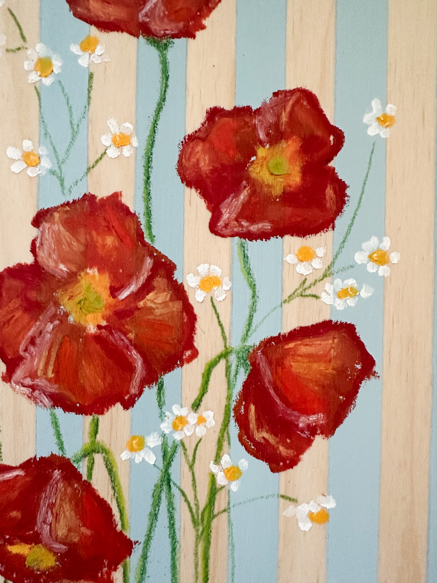 Painted red flowers with green stems and small white flowers on a striped background