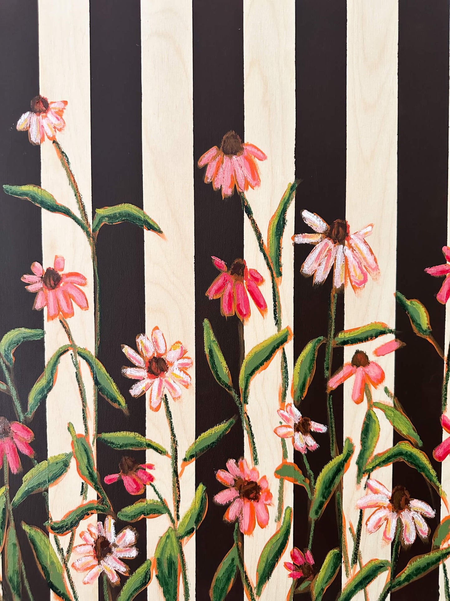 Floral pattern with pink flowers and green leaves on a black and white striped background