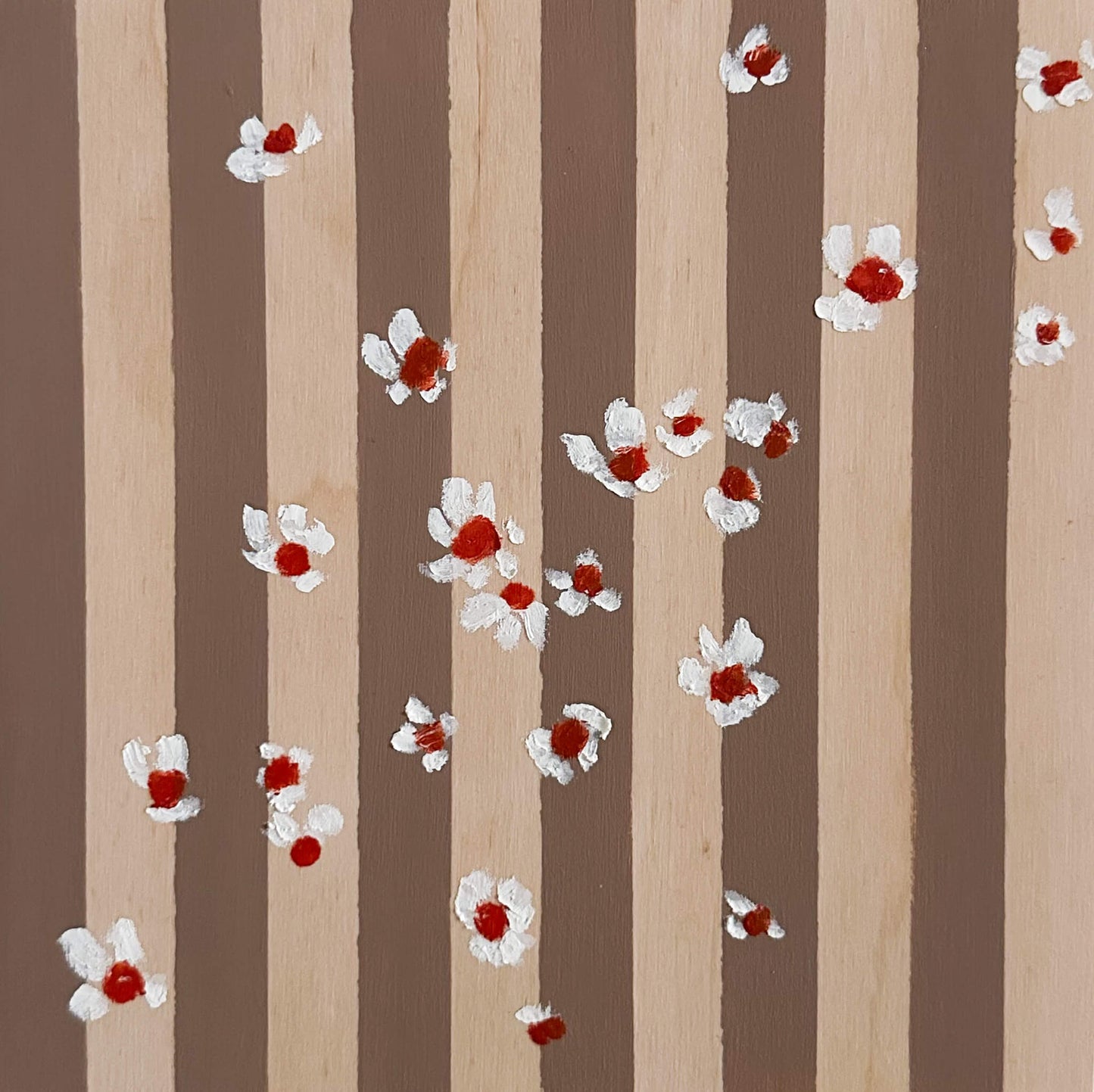 Pattern of white flowers with red centers on brown and wood striped wood panel