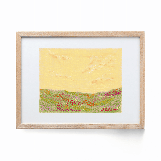 A colorful landscape print framed in a wood frame. The print shows a colorful flower field with a yellow sky.