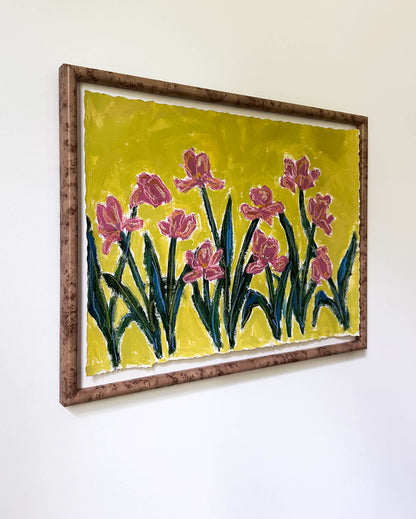 Framed artwork of pink flowers on a yellow background