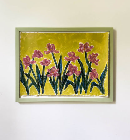Framed artwork of pink flowers on a yellow background