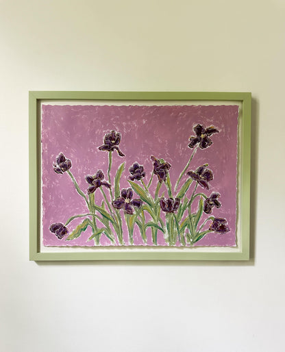 Framed artwork of purple flowers on a pink background