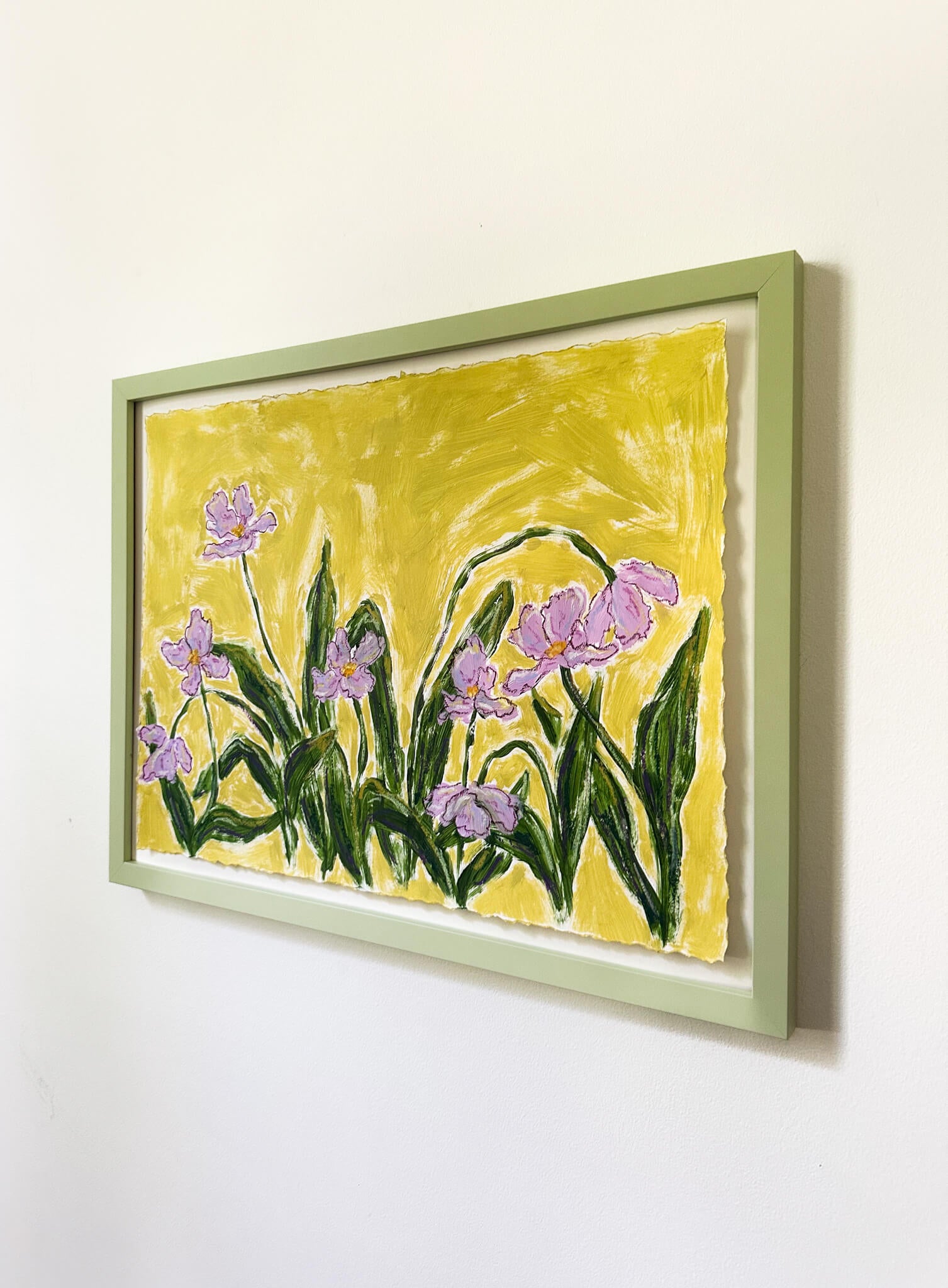 Framed painting of purple flowers on a yellow background