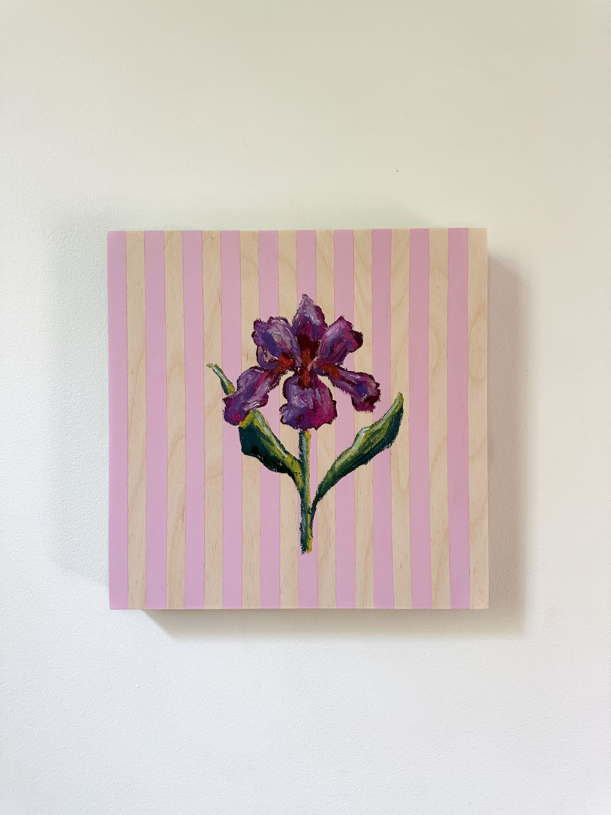 Canvas print of a purple flower on a pink and wood striped background