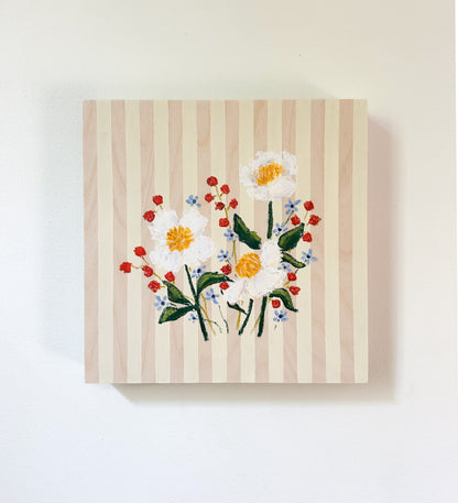 Floral embroidery on a striped fabric background