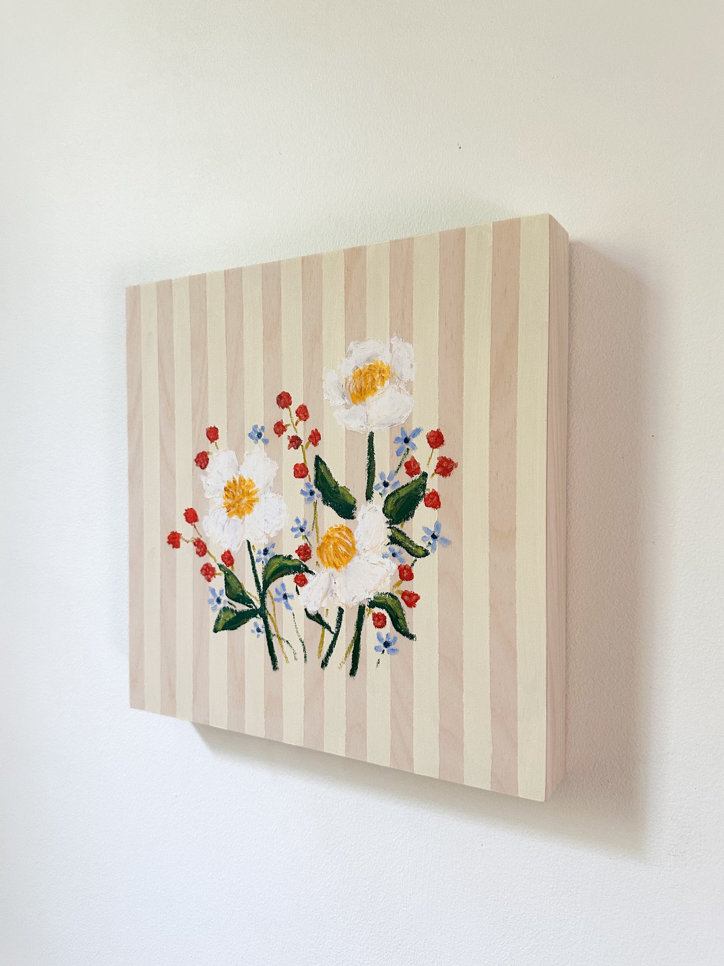 Canvas painting of flowers on a striped background