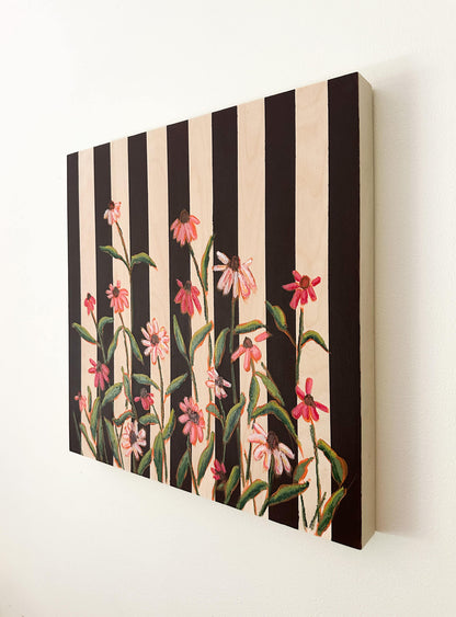 Floral pattern with pink flowers and green leaves on a black and white striped background
