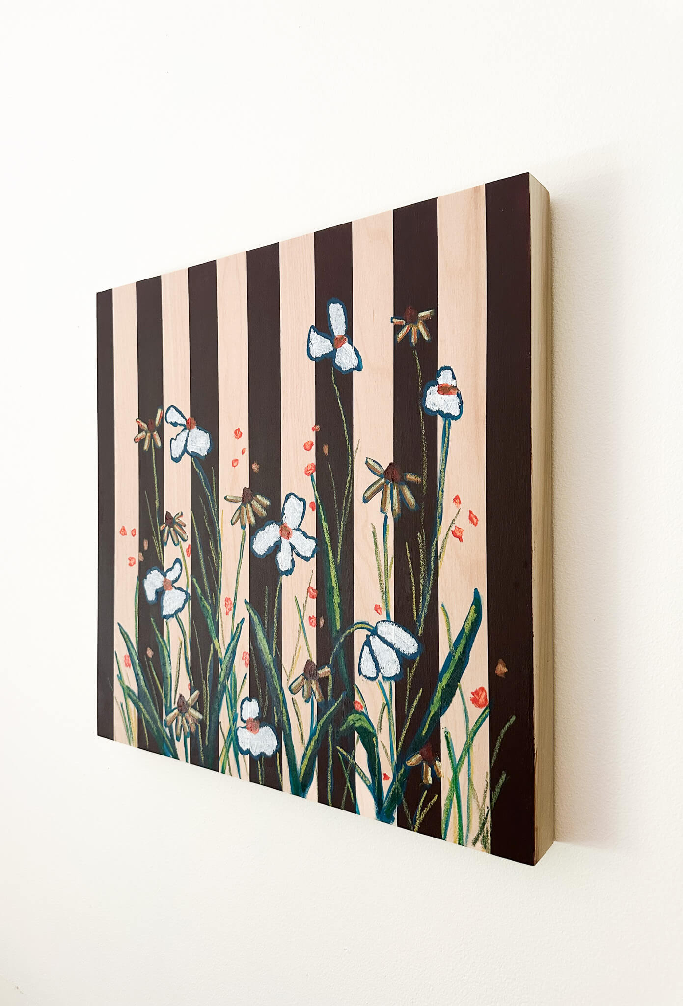 brown striped painting on wood background with white and orange flowers.