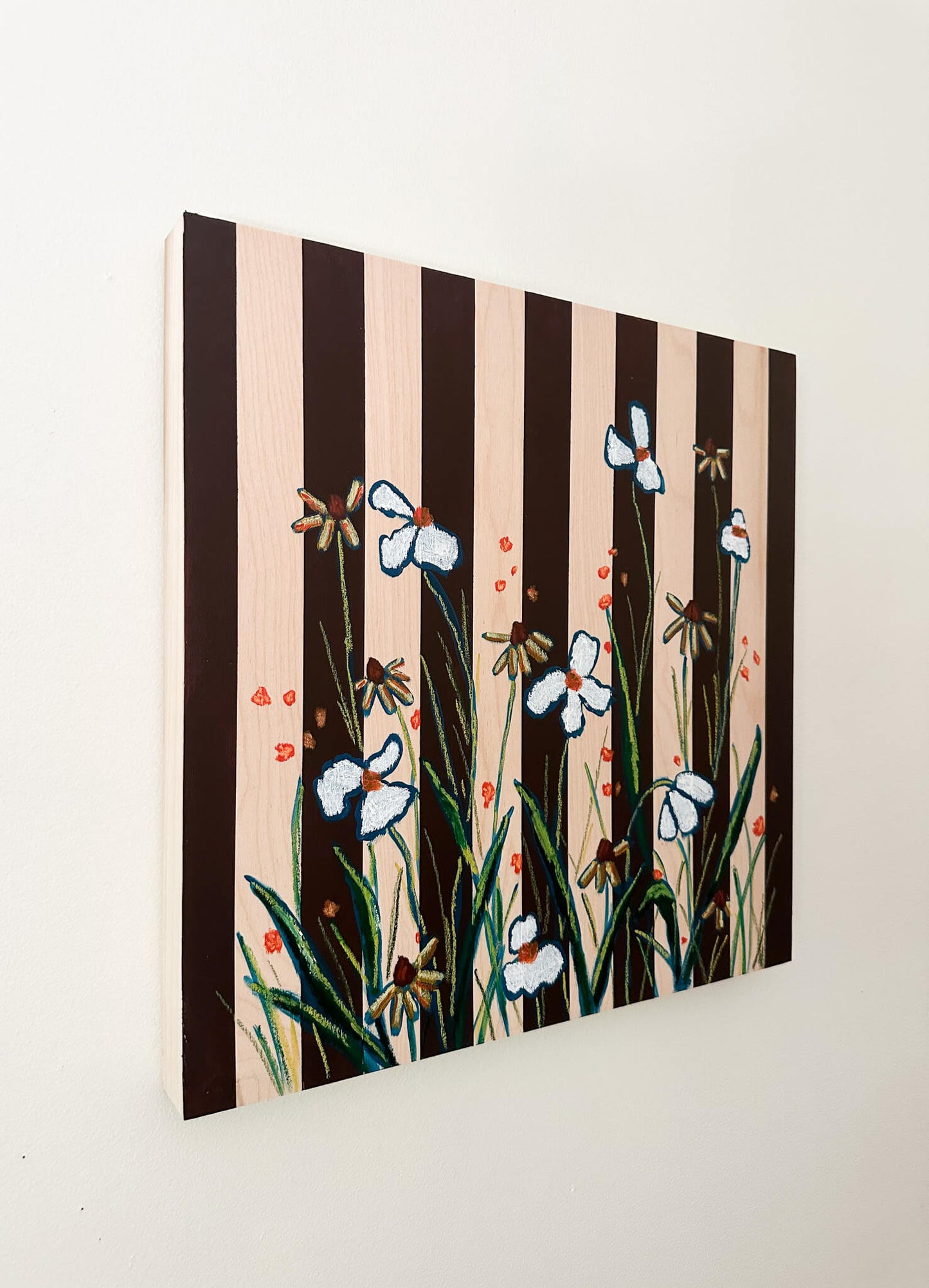 brown striped painting on wood background with white and orange flowers.
