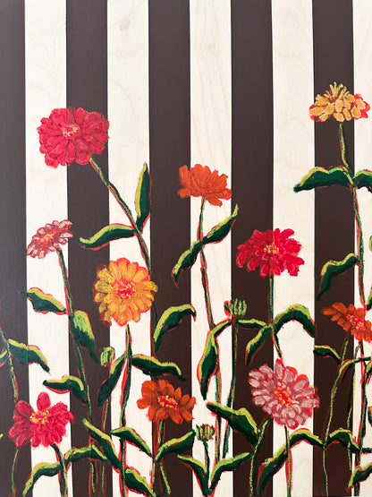 Floral artwork with black and white stripes on a white wall