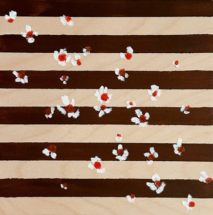 A brown and wood striped background with small white flowers with orange centers scattered across the art. 