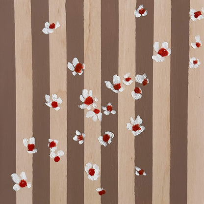 Pattern of white flowers with red centers on brown and wood striped wood panel