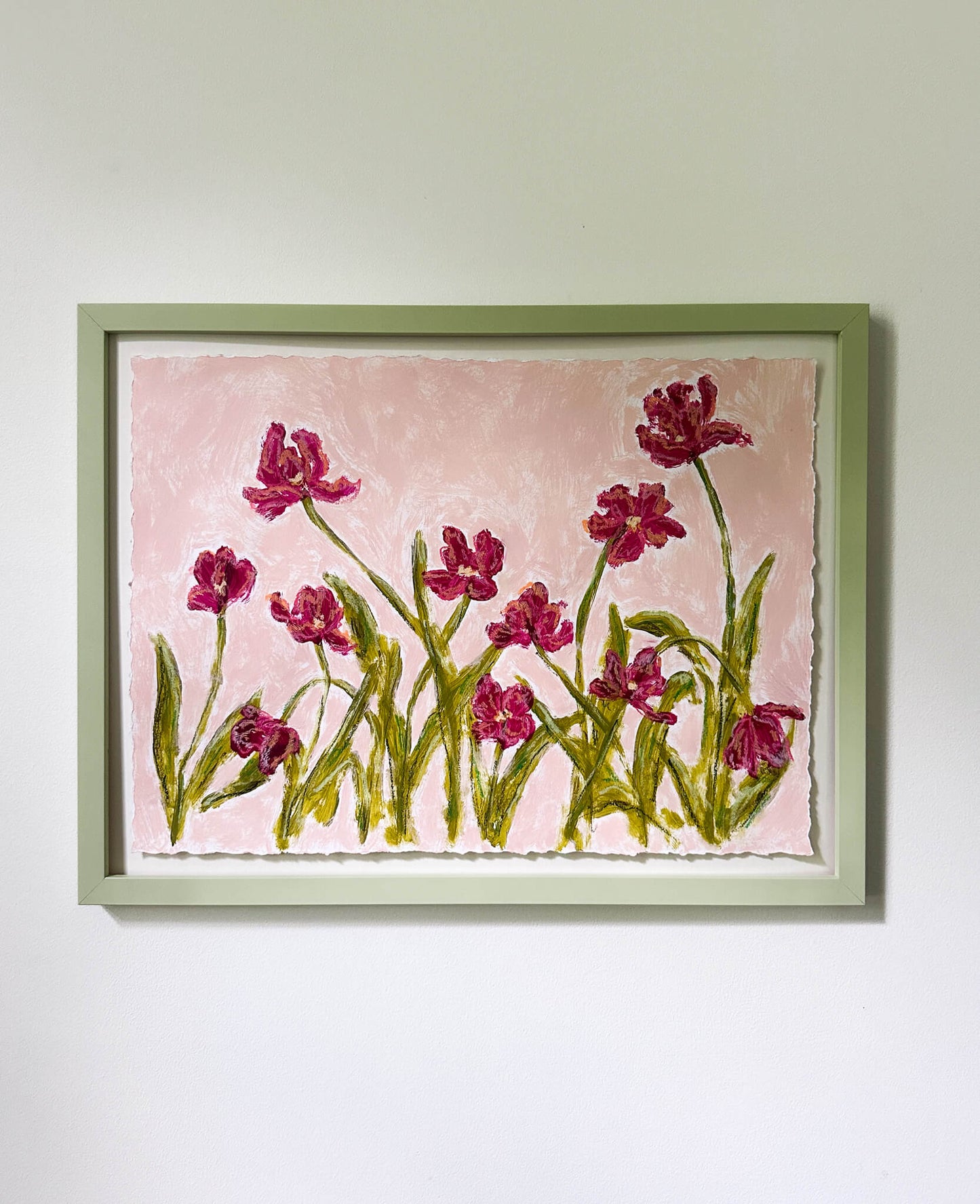 Framed artwork of pink flowers on a light pink background