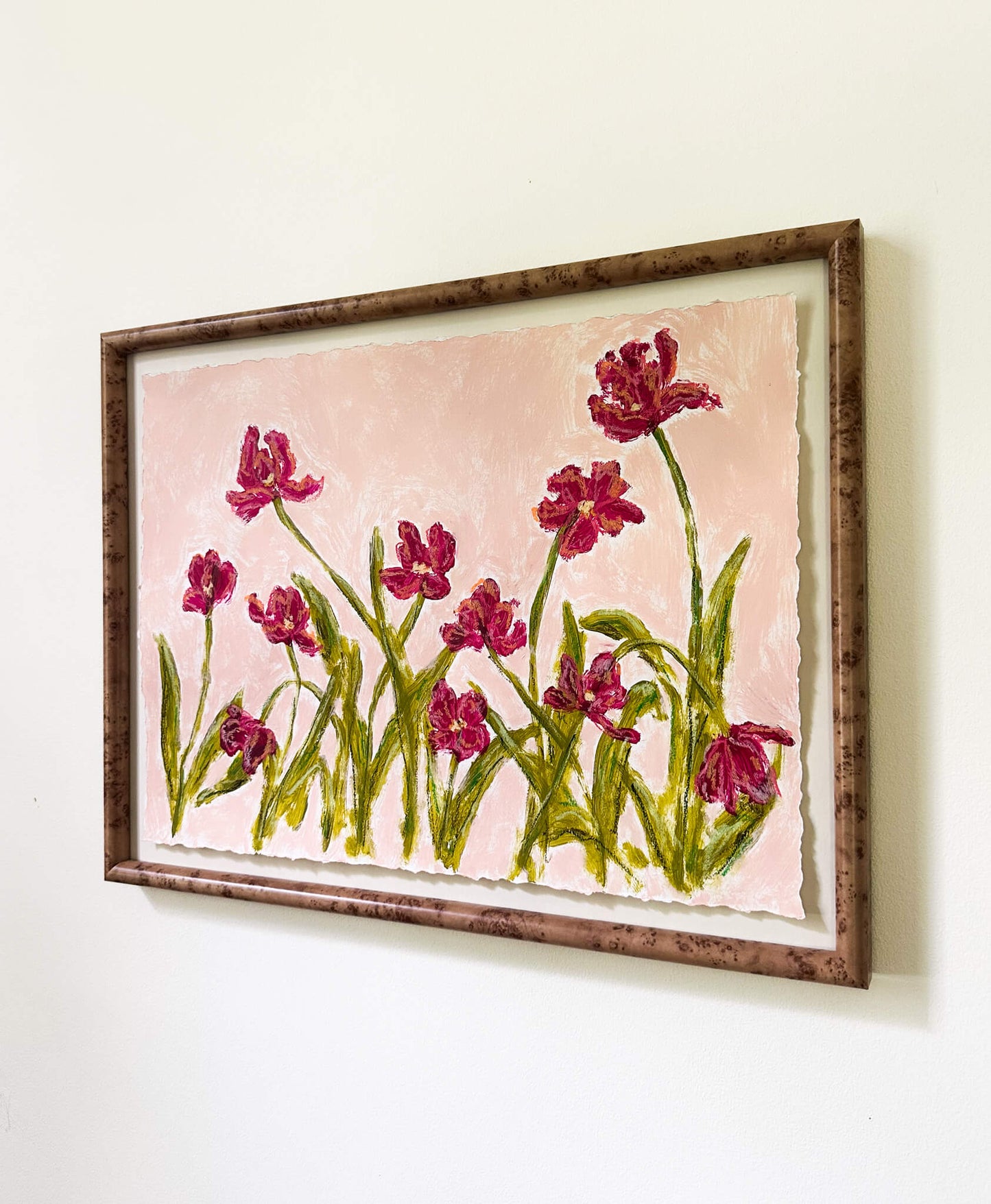 Framed artwork of pink flowers on a light pink background