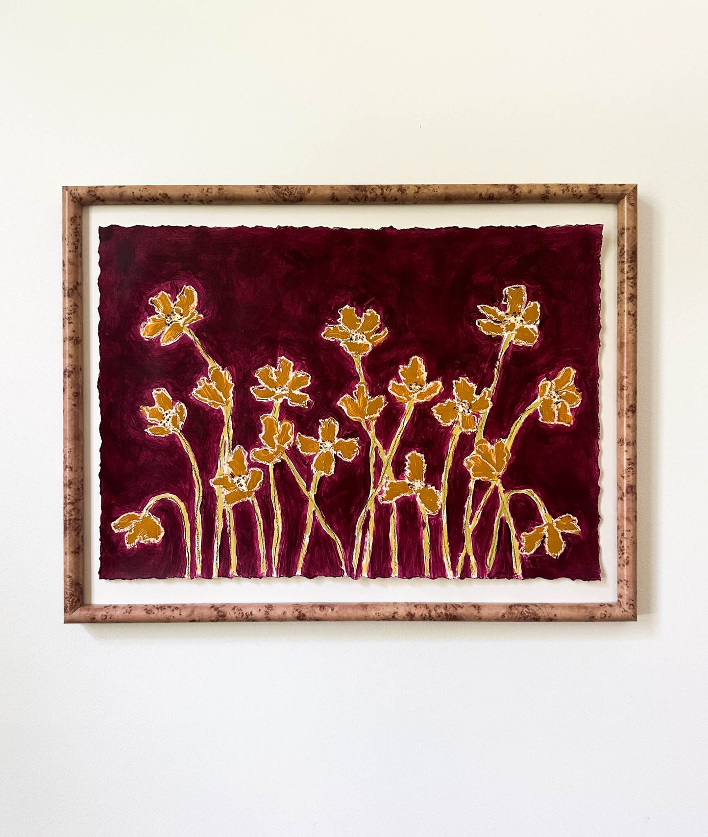 Framed artwork with gold floral design on a red background