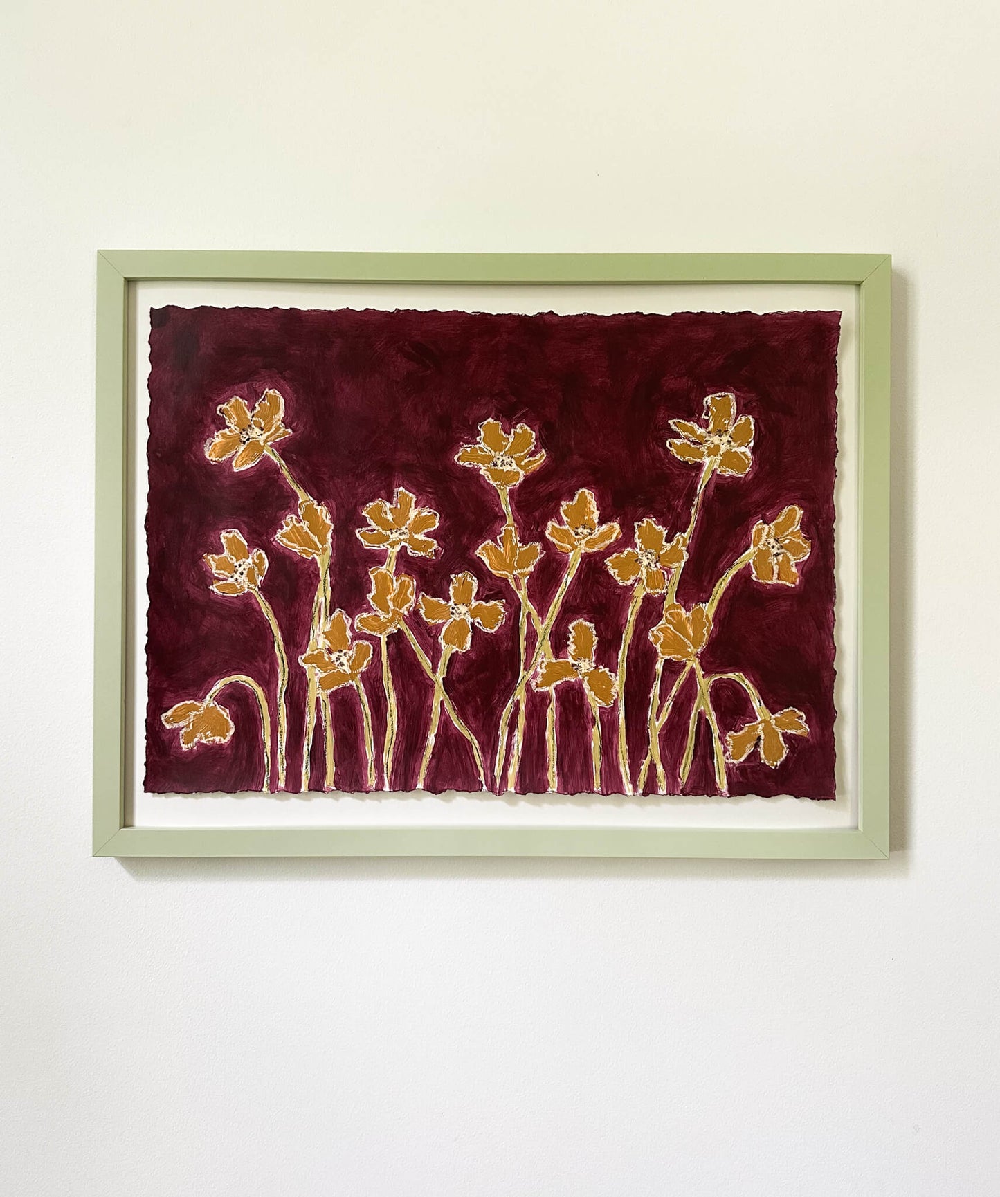 Framed artwork with floral design on a red background