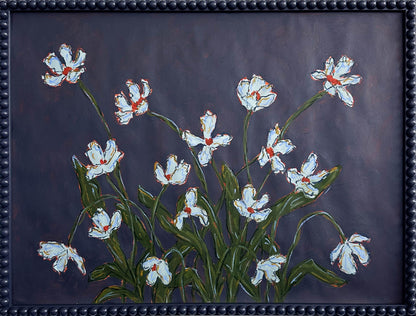A painting of light blue flowers with green leaves on a dark blue background framed in a dark blue bobbin frame. 