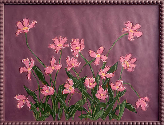A painting o pink flowers with green leaves on a  plum background framed in a plum bobbin frame.