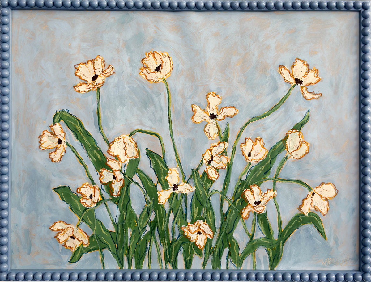 A painting of off white flowers with green leaves on a light blue background and framed in a blue bobbin frame.