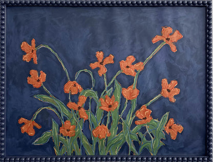 A painting of orange flowers with green leaves on a  deep blue background framed in a deep blue bobbin frame.