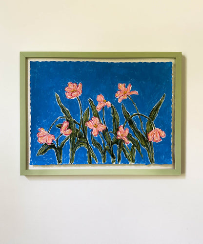 Framed artwork of pink flowers on a blue background