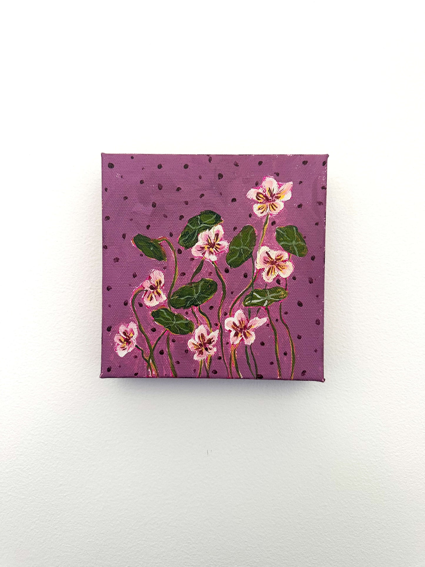 Small square canvas with floral design on a purple background