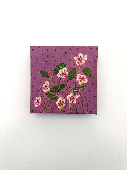 Small square canvas with floral design on a purple background