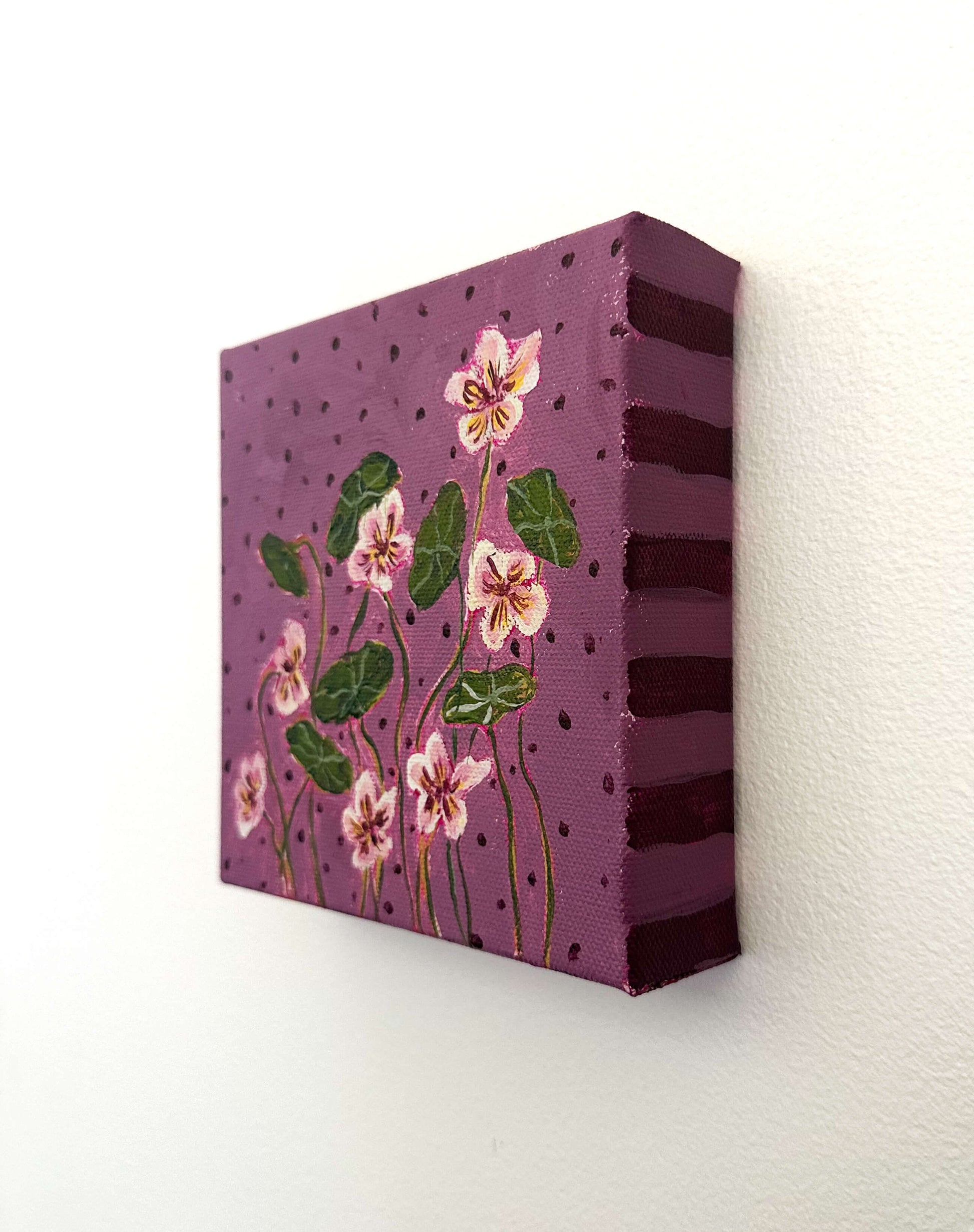 Canvas painting with floral design on a purple background