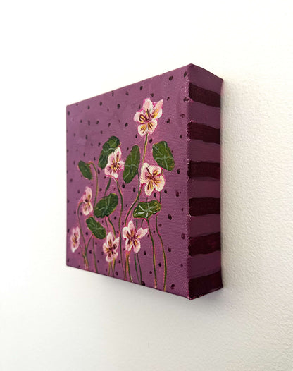 Canvas painting with floral design on a purple background