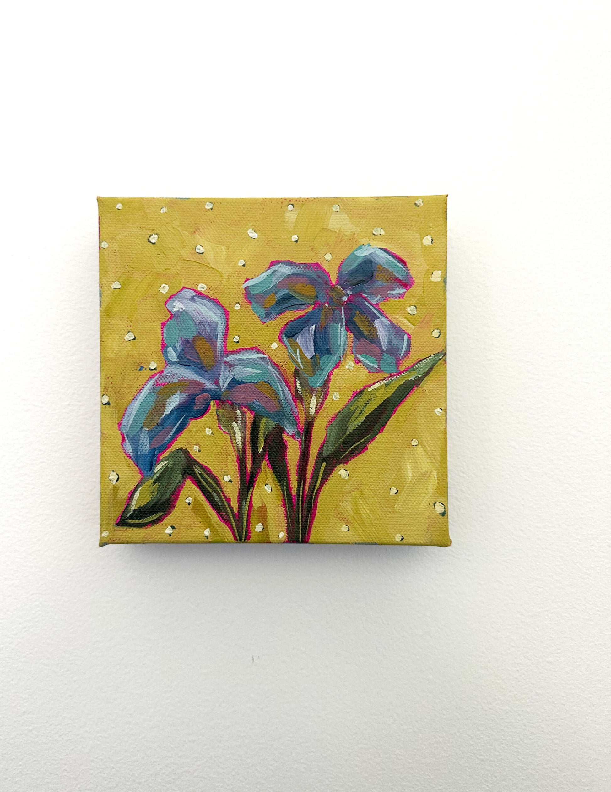 Painting of blue flowers on a yellow background