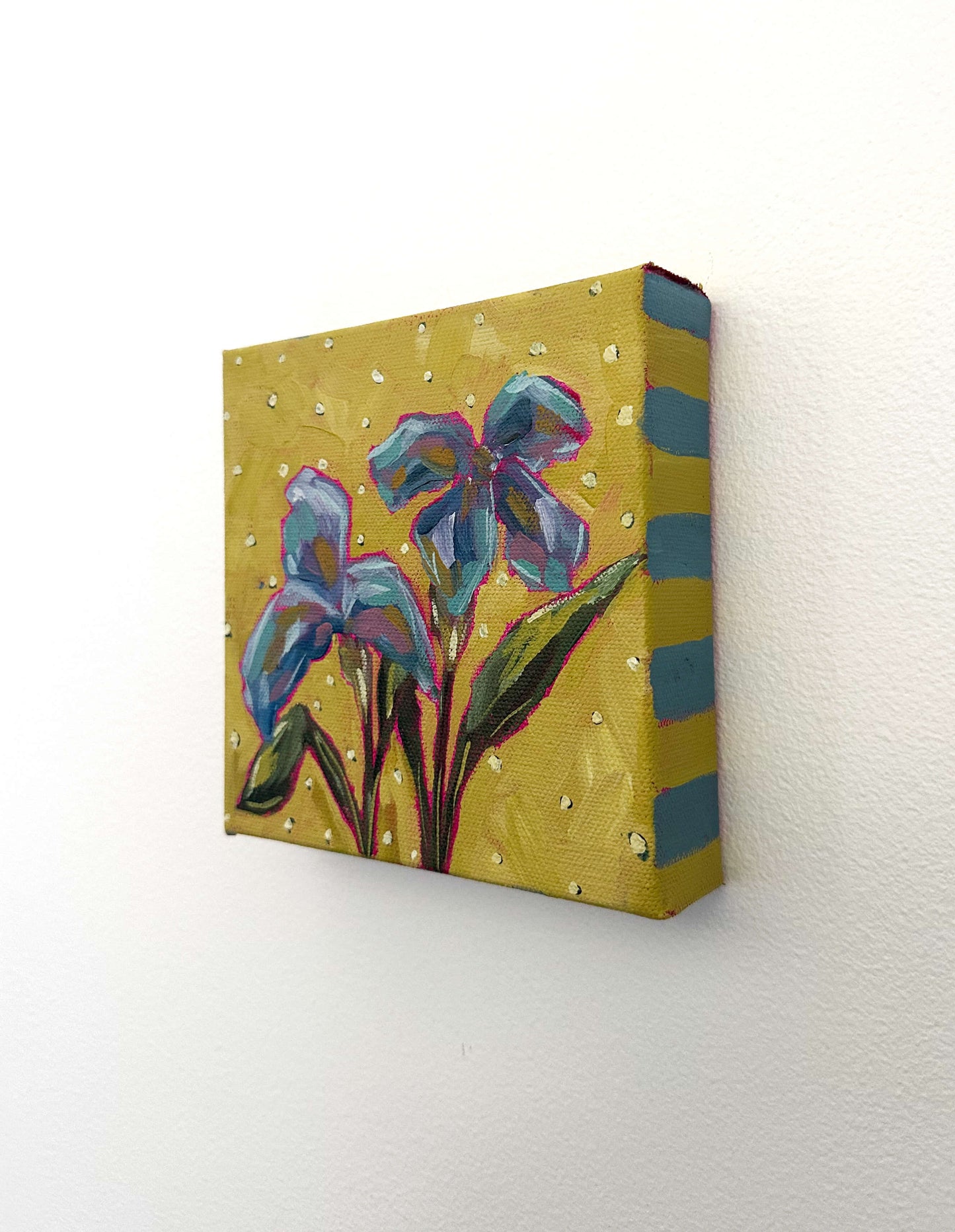 Canvas painting of colorful flowers on a yellow background