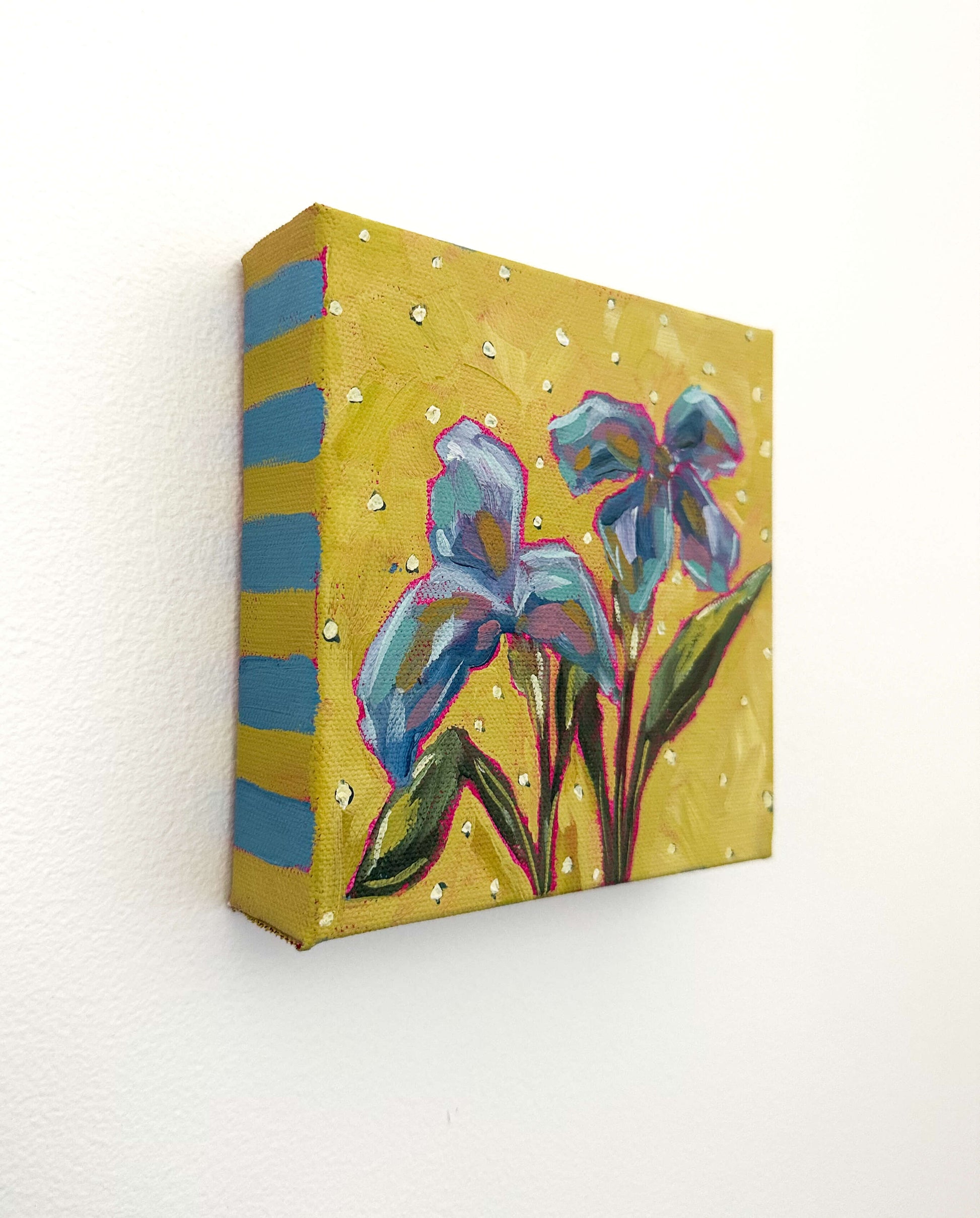 Decorative box with floral design and blue stripes on a white background