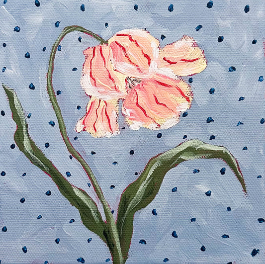 Painting of a pink flower with green leaves on a blue polka dot background