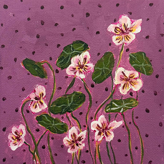 Floral design with pink flowers and green leaves on a purple background with black dots