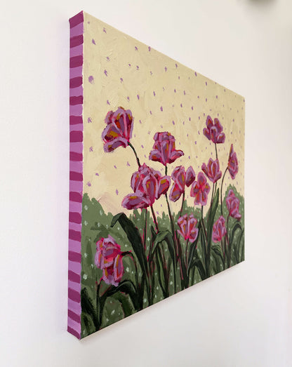 Canvas painting of pink tulips on a light yellow and purple polka dot background with a striped border, hanging on a white wall.