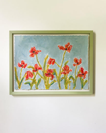 Framed painting of red flowers on a light blue background