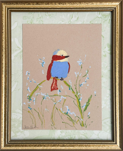 A painting of a colorful bird perched on a plant painted on tan paper and mounted on light green fabric. The painting is in a gold frame. 
