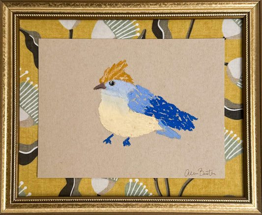 a bird painting with blue and yellow oil pastels on tan paper, mounted on yellow fabric and framed in a gold frame.