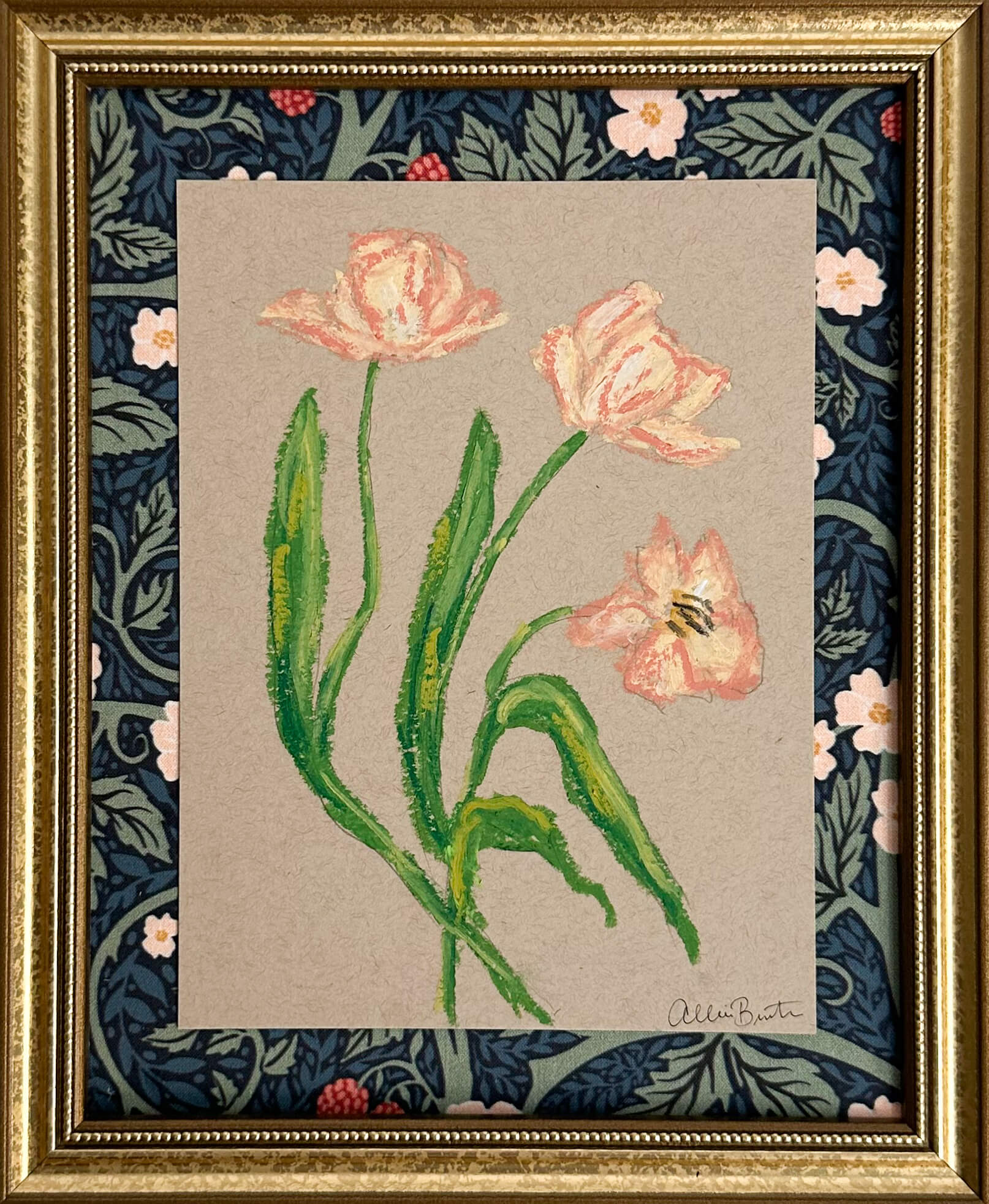 peach florals painted with oil pastels on tan paper, mounted on floral fabric and framed in a gold frame.