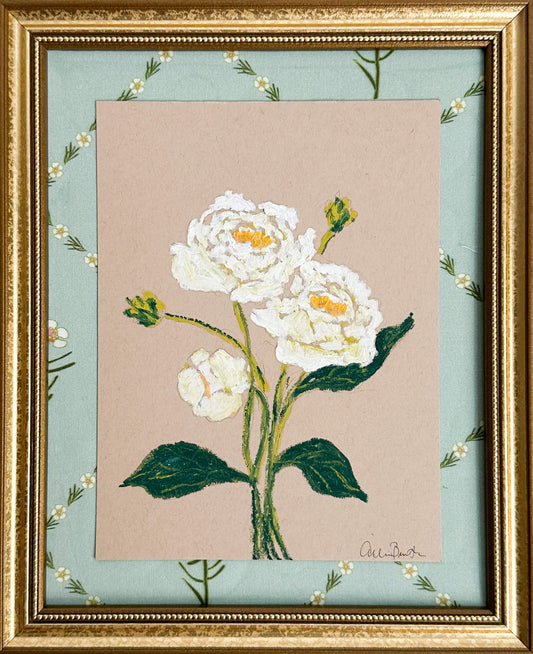 A painting of white peonies on tan paper mounted on floral fabric. The painting is in a gold frame.