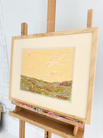 Landscape painting of a landscape on an easel with a white background