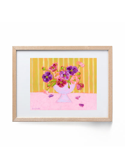 Framed artwork of a colorful bouquet of flowers on a yellow and pink striped background.