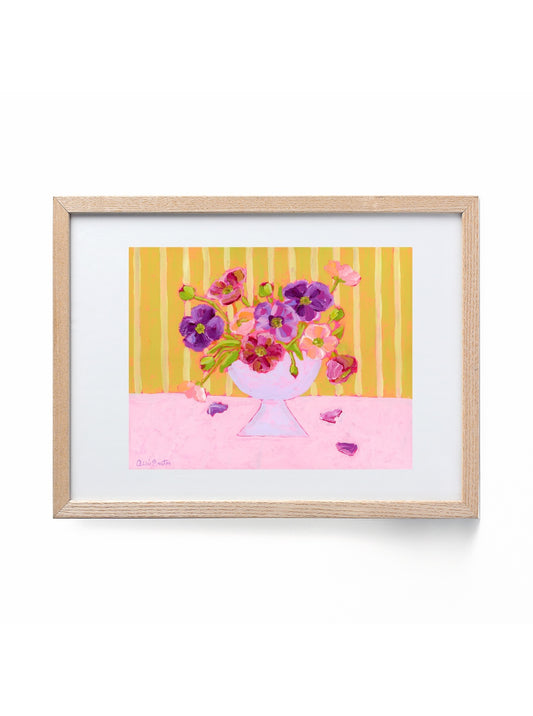 Framed artwork of a colorful bouquet of flowers on a yellow and pink striped background.