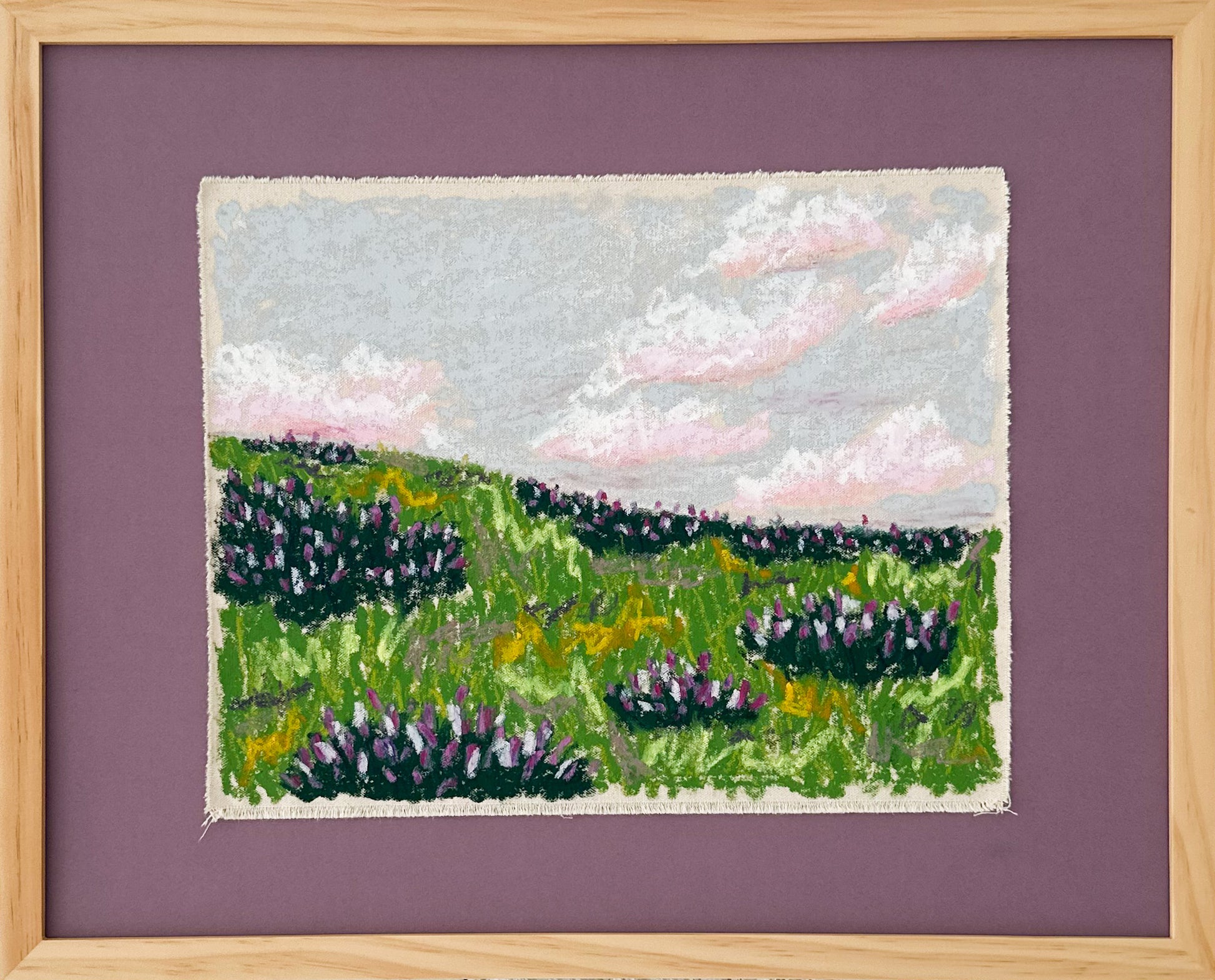 Framed  canvas  art of a landscape with green fields and purple flowers on a purple background