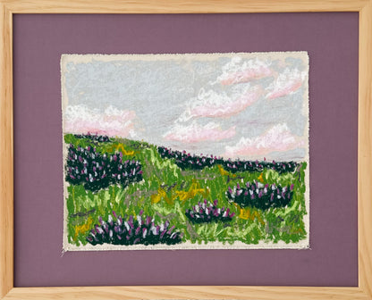 Framed  canvas  art of a landscape with green fields and purple flowers on a purple background