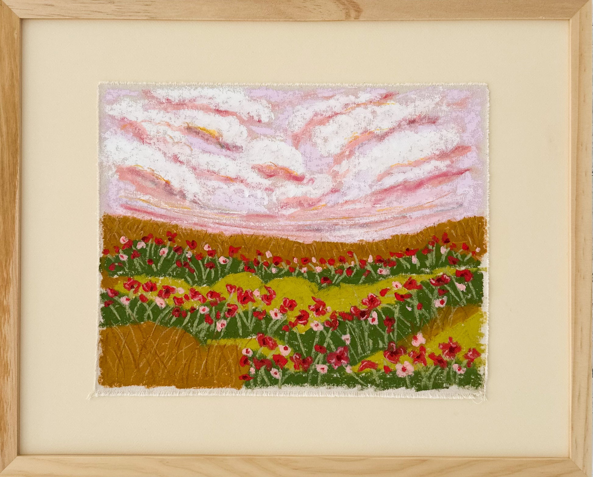 Framed canvas art piece depicting a landscape with flowers and clouds.