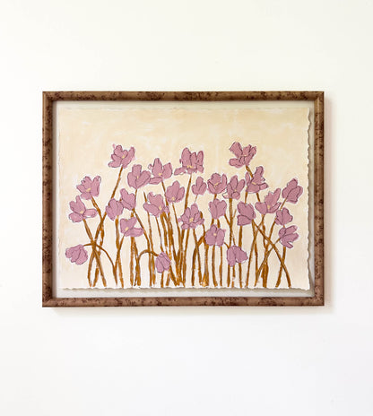a framed painting of mauve flowers with yellow stems painted on a beige background and hung on a white wall.