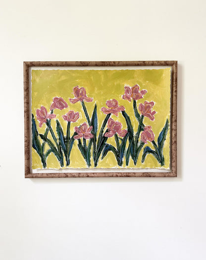 a framed painting of mauve flowers with green stems painted on a bright greenish yellow background and hung on a white wall.